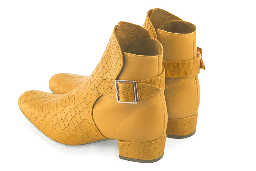 Mustard yellow women's ankle boots with buckles at the back. Round toe. Low block heels. Rear view - Florence KOOIJMAN